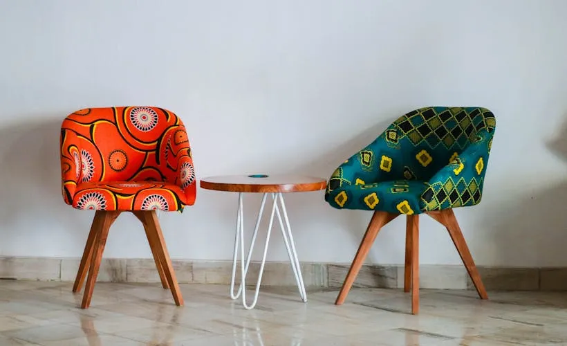 Two Assorted-color Padded Chairs Near Side Table